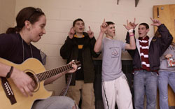 Image of Erin Haskell, a parishoner at Immaculate Conception Church in Greene, plays some worship songs on her guitar for other youths attending the FX Youth Rally at St. Matthew's School.
