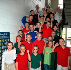 Image of STUDENT WITH BRAIN TUMOR SURROUNDED BY CLASSMATES, TEACHERS - Chad Scanlon, in a blue jacket, a sixth-grader at Holy Trinity School in Ligonier, Pa., is surrounded in 2006 by classmates, friends and teachers who had gotten buzz cuts to support him during his cancer treatments. While Chad has been battling a brain tumor, he has kept his focus on other things, including making a collection of postcards from all 50 states and every country around the world. (CNS photo/Ed Zelachoski, The Catholic Accent) 