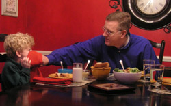 Image of DINNER IS TIME FOR INDIANAPOLIS FAMILY TO PRAY TOGETHER
Howard Egger wipes the face of his 5-year-old son, Charlie, during dinner - a time when the Egger family regroups and prays together. During Lent Charlie's parents are getting him involved in cooking creative alternatives to traditional meatless meals on Fridays, a far cry from previous generations' dinners of tomato soup and grilled-cheese sandwiches, fish and filet-of-fish sandwiches from a fast-food restaurant. (CNS photo/John Shaughnessy, The Criterion) 
