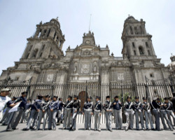 Image of Police stand in front of the cathedral in Mexico City in this file photo from April. Services at the cathedral were suspended by the Mexico City Archdiocese after leftist protesters disrupted a Nov. 19 Mass. (CNS photo/Reuters)