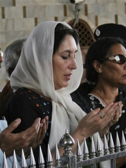 Image of Pakistan's former Prime Minister Benazir Bhutto offers prayers at the tomb of Mohammad Ali Jinnah, founder of Pakistan,in this Oct. 22, 2007 file photo, in Karachi, Pakistan. Opposition leader Bhutto died Thursday, Dec. 27, 2007, a party aide said. A party security adviser says Bhutto was shot in the neck and chest as she got into her vehicle, then a gunman blew himself up.