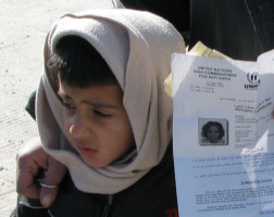 Image of A young Iraqi boy, his mother holding in her hand the official documentation granting him refugee status.The process is painstakingly long and arduous.With more than 4 million people displaced, Iraqis are the third largest and the fastest-growing refugee population in the world. Although the U.S. promised to receive 7,000 Iraqi refugees by October 2007, only 1608 were resettled in the U.S. 