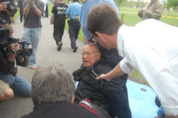 Image of (Fr. Norm Weslin of Lambs of Christ being arrested.)