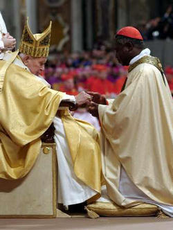 Image of Cardinal Peter Kodwo Appiah Turkson, the archbishop of Cape Coast, Ghana.  Newly elevated Cardinal Turkson receives his cardinal ring from Pope John Paul II during a special mass in Saint Peter's Basilica at the Vatican October 22, 2003.