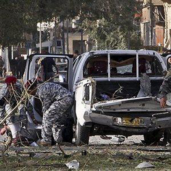 Image of Iraqi police evacuate a victim of a bomb attack in Baghdad, Iraq, Monday, Jan. 25, 2010.