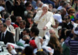 Image of Pope greets crowd at a General Audience from his Popemobile