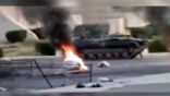 Image of A Syrian armored personnel carrier rolls into the site of civilian anti-government protests.