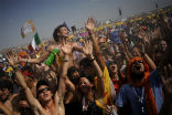 Image of Festive pilgrims are showered with water to help relieve the 104 degree heat in Madrid. 