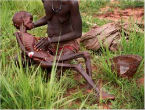 Image of Islamic warlords eat while mothers watch the children starve.
