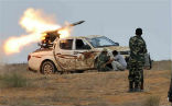 Image of NTC fighters fire a rocket at Qaddafi loyalists in Sirte. 