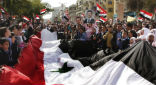 Image of Pro-government demonstrators rally in Syria.