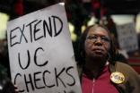Image of An unemployed woman protests for the extension of unemployment benefits. The future remains bleak for the long-term unemployed as their skills become outdated.