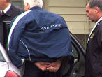 Image of A still frame from video of Sandusky's rearrest.