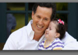 Image of Rick Santorum at a campaign stop, holding his daughter Bella