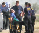 Image of Captain Osborn deplanes strapped to a chair.