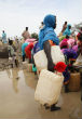 Image of Refugees struggle to obtain what little water they can as supplies run out. 