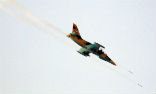 Image of A Syrian warplane fires its rockets. 