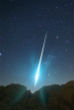 Image of An exceptionally bright Geminid streaks across the sky in this photo. 