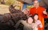 Image of Former cardinal Keith O'Brien with Jimmy Sevile and two unidentified children. Police suspect the late Sevile is one of the country's worst serial sexual predators. 
