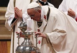 Image of Pope Francis blows on the Oil of Chrism as it is blessed for distribution to the Churches  