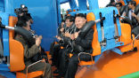 Image of Kim Jong Un prepares to ride a roller coaster, accompanied by his generals. 