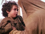 Image of Mother working with her children