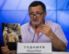 Image of Abdul- Baki Todashev holds his son's autopsy photo which he claims shows his son was executed. 