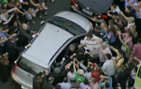 Image of A mob crowds against the Pope's vehicle following his arrival in Rio. 