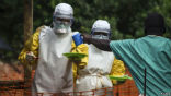 Image of Aid workers in Sierra Leone distribute food to patients infected with Ebola.