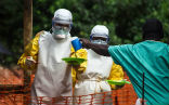 Image of Aid workers provide supplies to an Ebola infected man in West Africa. So far, 2,000 people have been killed by the outbreak that began in early 2014.