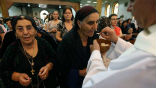 Image of Iraqi Christians receive communion in the Kurdish city of Arbil. Sunday was the first time in 2,000 years no communion was offered in Nineveh, because no Christians remain. 