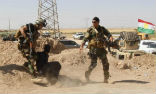 Image of Kurdish forces with a captured Islamic State fighter.