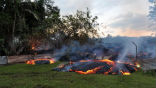 Image of Lava from the Kilauea volcano on the island of Hawaii threatens to destroy the village of Pahoa and now it sits within 100 yards of the first house.
