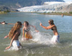 Image of Swimmers keep cool playing in an Alaskan lake amid record-breaking heatwaves in the state. 