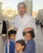 Image of Raif Badawi stands with his children. His wife and kids fled to Canada after his arrest.