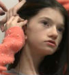 Image of 14-year-old Maggie was born completely deaf.