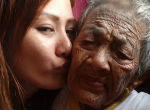 Image of Granddaughter cares for elderly grandmother who can niether stand nor walk (Jen Ampler/Facebook).