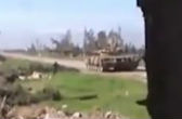 Image of Syrian rebel throws grenade into tank.