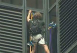 Image of The crowd beneath the unidentified climber could only stare and pray he wouldn't fall.