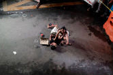 Image of A woman weeps over the body of her husband, who was killed in Manila (Czar Dancel/Reuters).