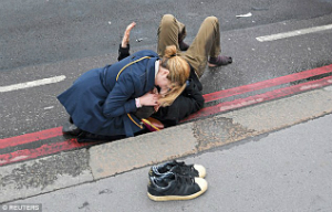 A women comforts a victim who survived the attack with injuries. Several people have serious injuries.