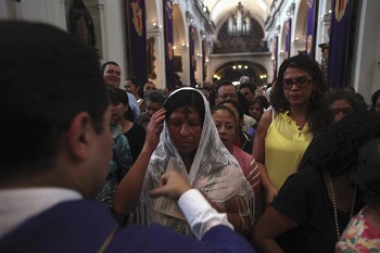 A penitent Christian coming forward to receive ashes at an Ash Wednesday liturgy