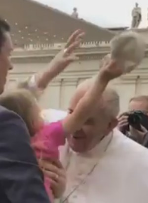 Estella removed Pope Francis' skullcap when the Pontiff leaned in for a kiss.
