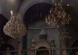 Image of Priest visits Catholic church (not pictured) after ISIS clears out.