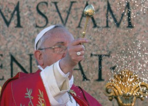 Pope Francis reads his Palm Sunday homily during mass.