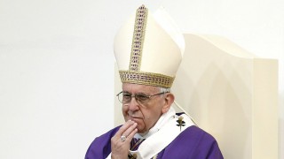 Pope Francis witnesses a bishop collapse at the altar (Reuters).