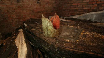 A gold mitre rested atop one of the lead coffins in the crypt. How did it get there?