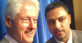 Awan with Bill Clinton. Awan is accused of breaking a number of crimes including transferring sensitive data offsite and fraud.