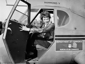 A new photograph appears to show Earhart and Noonan awaiting transport on a ship towing their wrecked plane.