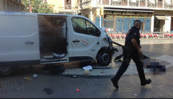 An officer walks past the van used in the attack.